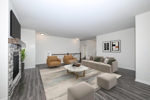 living room with a fireplace and dark hardwood / wood-style flooring