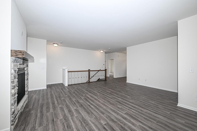 unfurnished living room featuring dark hardwood / wood-style floors and a fireplace