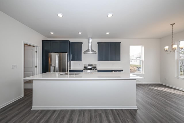 kitchen featuring range, wall chimney range hood, dark hardwood / wood-style flooring, an island with sink, and stainless steel refrigerator with ice dispenser