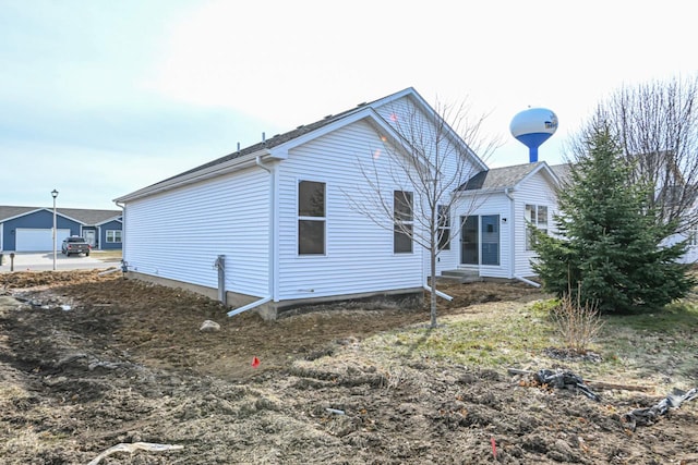 back of property featuring a garage