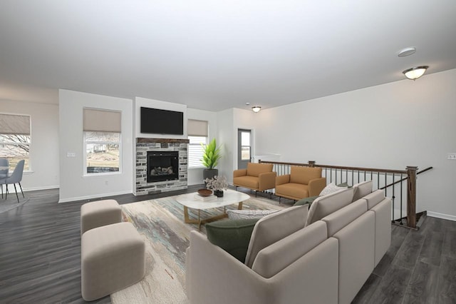 living room featuring a stone fireplace and dark wood-type flooring