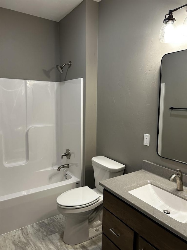 full bathroom featuring vanity, toilet, and washtub / shower combination