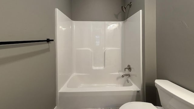 bathroom featuring toilet and shower / bathtub combination