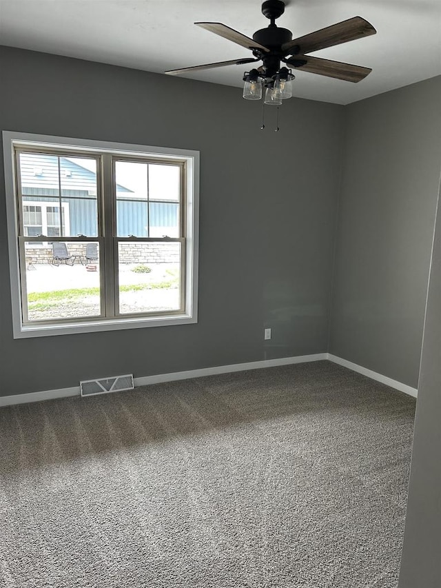 empty room with carpet floors and ceiling fan