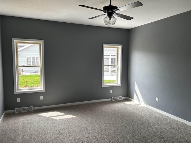 spare room featuring carpet flooring and ceiling fan