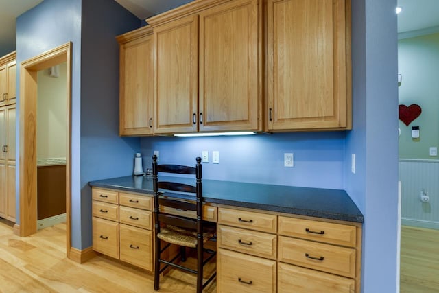 3310 Saracen Way, Verona, WI 53593 - home office with built in desk, light wood-style floors, and a wainscoted wall