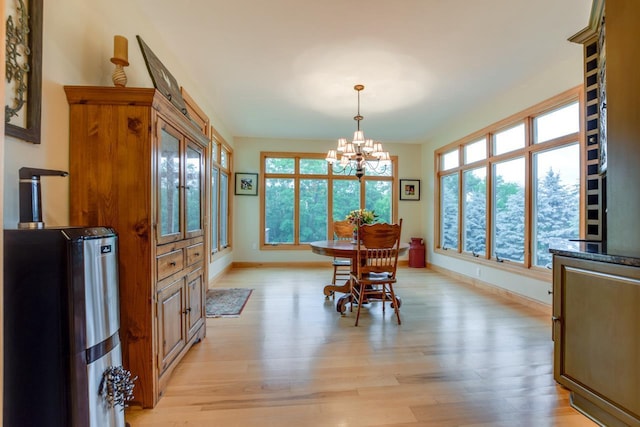 3310 Saracen Way, Verona, WI 53593 - dining area featuring a chandelier, plenty of natural light, and light wood finished floors