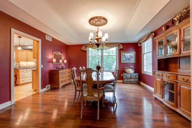3310 Saracen Way, Verona, WI 53593 - dining room with a chandelier, a tray ceiling, and dark wood-type flooring
