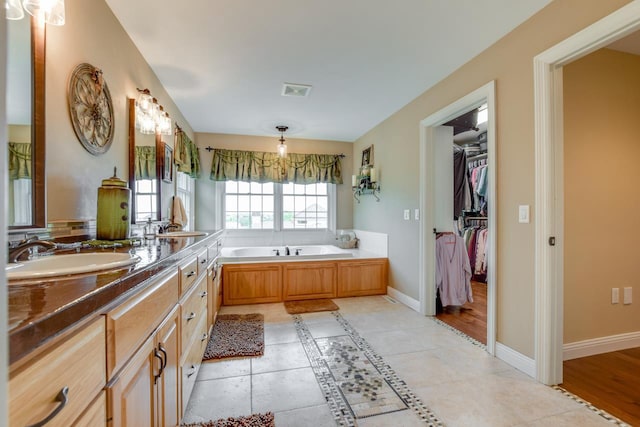 3310 Saracen Way, Verona, WI 53593 - bathroom with a garden tub, a spacious closet, tile patterned floors, and double vanity