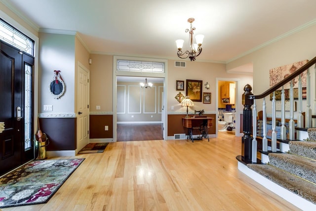 3310 Saracen Way, Verona, WI 53593 - foyer with a chandelier, stairs, wood finished floors, and ornamental molding