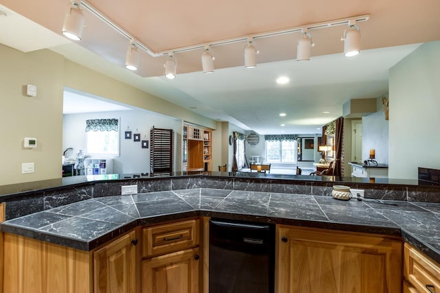 3310 Saracen Way, Verona, WI 53593 - kitchen with brown cabinetry, open floor plan, rail lighting, and tile counters