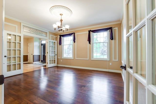3310 Saracen Way, Verona, WI 53593 - empty room featuring french doors, a chandelier, ornamental molding, and wood-type flooring