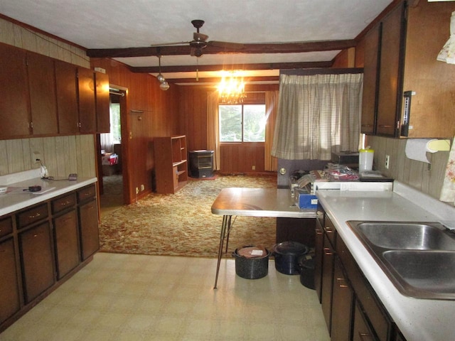 kitchen featuring light carpet, ceiling fan, beamed ceiling, and dark brown cabinets