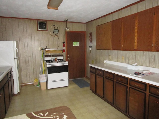 kitchen with white appliances, ornamental molding, light tile floors, and wooden walls