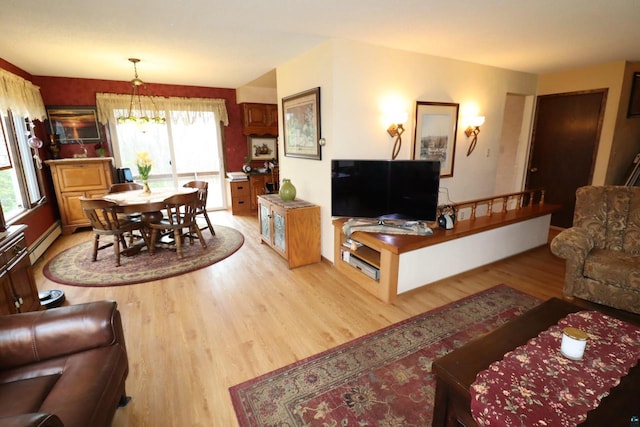 living room featuring a chandelier, light hardwood / wood-style flooring, and a baseboard radiator