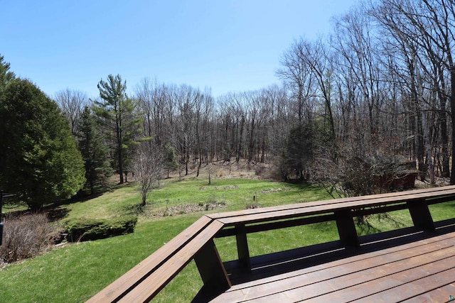 wooden terrace featuring a yard