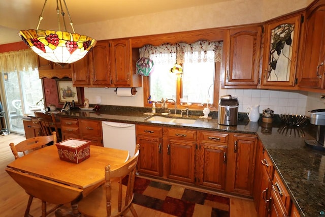 kitchen featuring dishwasher, light wood-type flooring, plenty of natural light, and sink