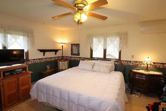 bedroom with carpet, ceiling fan, and multiple windows