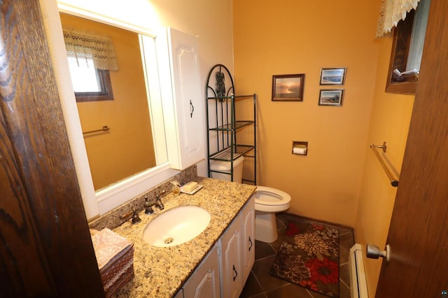 bathroom featuring tile patterned floors, vanity, toilet, and a baseboard radiator