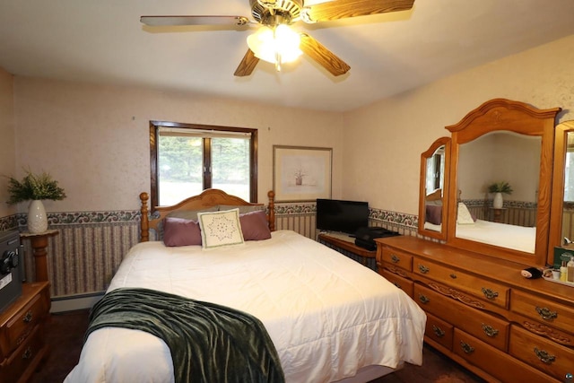 bedroom with ceiling fan and baseboard heating