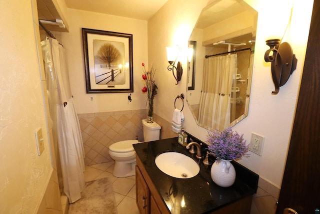 bathroom featuring tile patterned floors, toilet, vanity, tile walls, and a shower with shower curtain