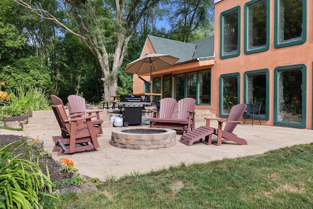 view of terrace with an outdoor fire pit