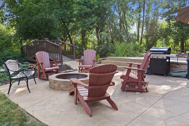 view of patio / terrace featuring a grill and an outdoor fire pit