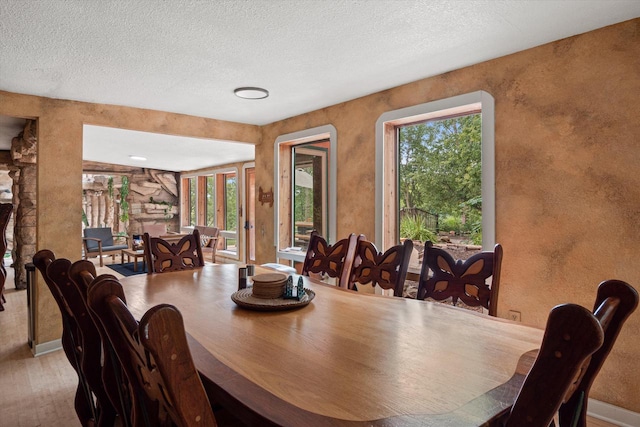 dining space featuring a textured ceiling