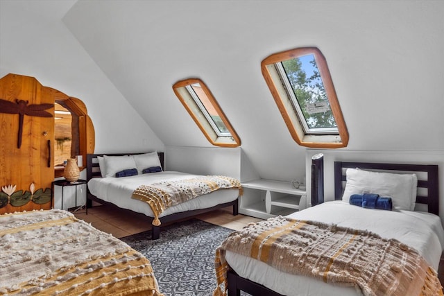 bedroom with lofted ceiling with skylight and tile flooring