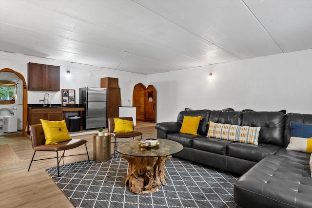 living room featuring dark hardwood / wood-style flooring and sink