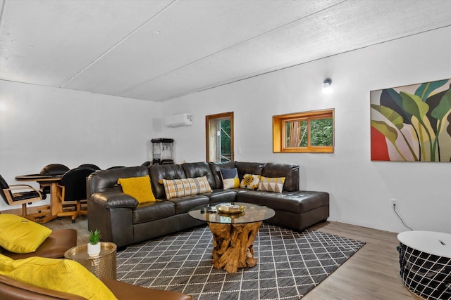 living room featuring a wall unit AC and hardwood / wood-style floors