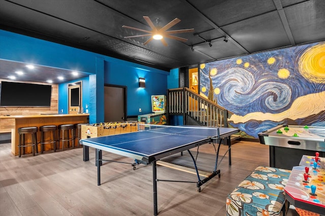 playroom with ceiling fan and hardwood / wood-style floors