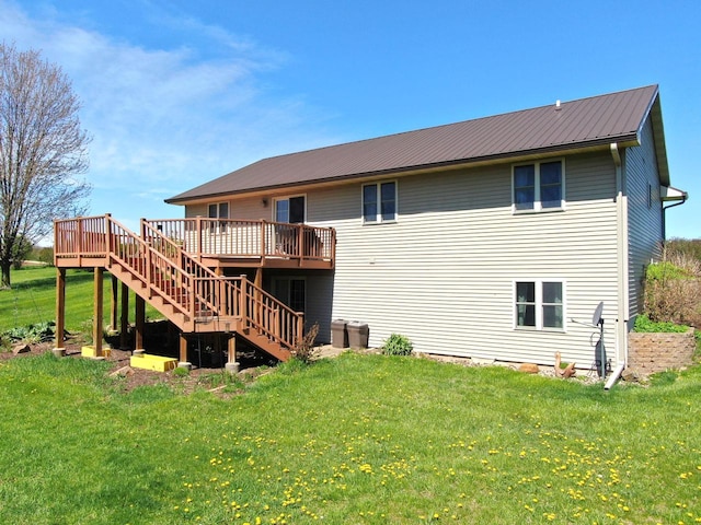 back of house featuring a wooden deck and a yard