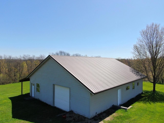 view of side of home featuring a garage and a lawn