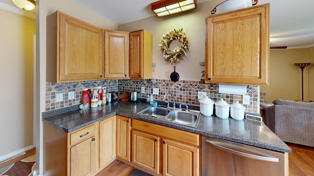 kitchen with sink, light hardwood / wood-style flooring, tasteful backsplash, and dishwasher