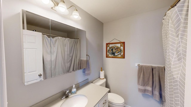 bathroom featuring oversized vanity and toilet