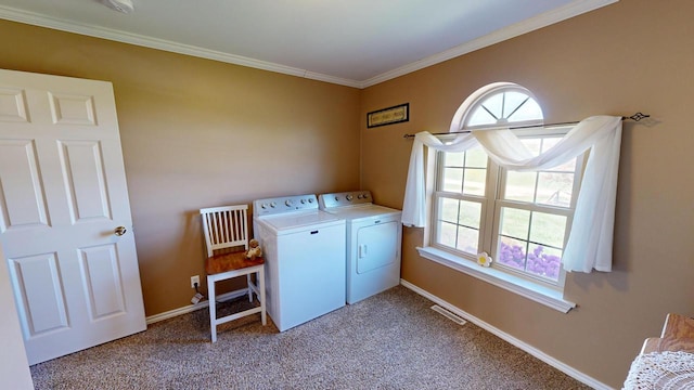 laundry area featuring a healthy amount of sunlight, crown molding, washing machine and dryer, and carpet flooring