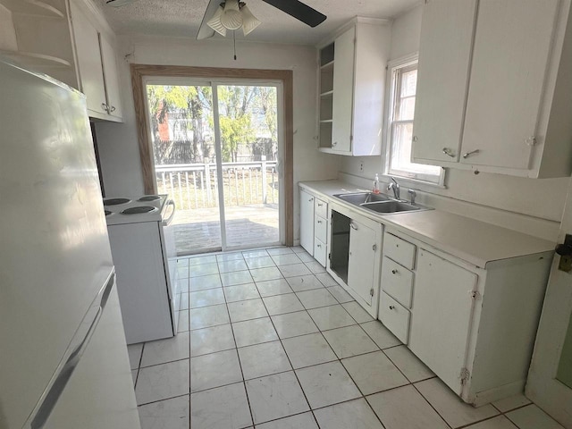 kitchen featuring a sink, open shelves, white cabinets, and light countertops