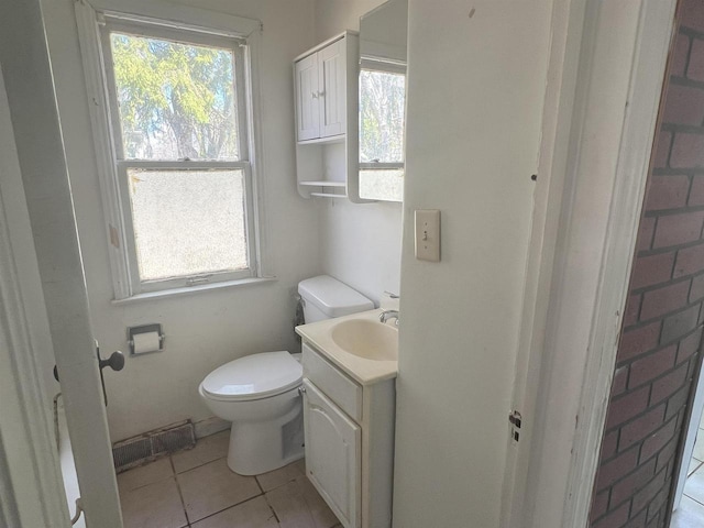 bathroom featuring tile patterned flooring, visible vents, vanity, and toilet