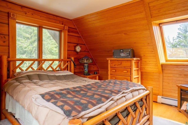 bedroom featuring wood walls, a baseboard heating unit, hardwood / wood-style floors, and vaulted ceiling