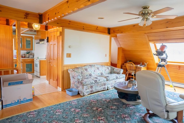 office featuring wood walls, ceiling fan, and light wood-type flooring