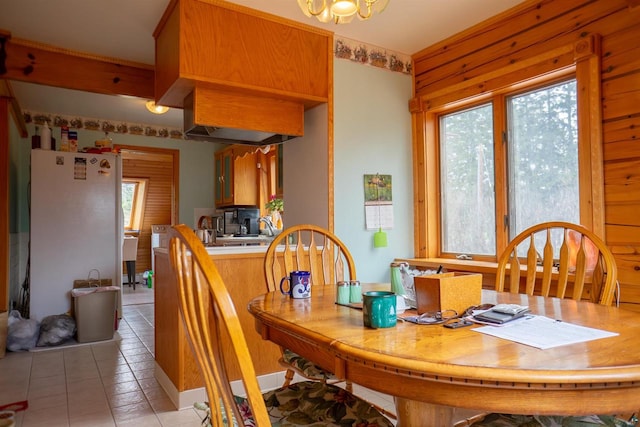 dining space featuring light tile floors