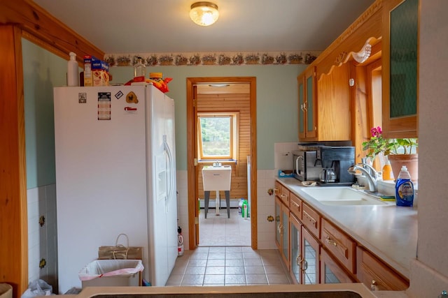 kitchen with white refrigerator, sink, and a baseboard heating unit