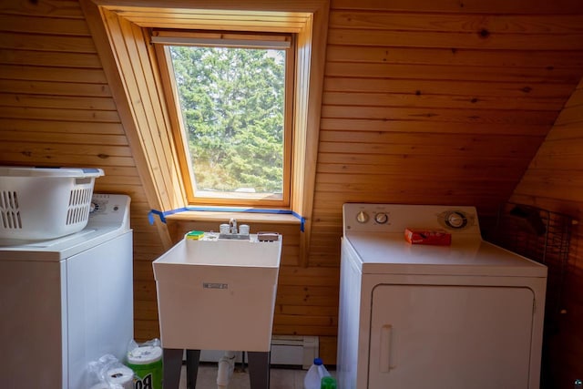 laundry room featuring sink, washer and dryer, and wooden walls