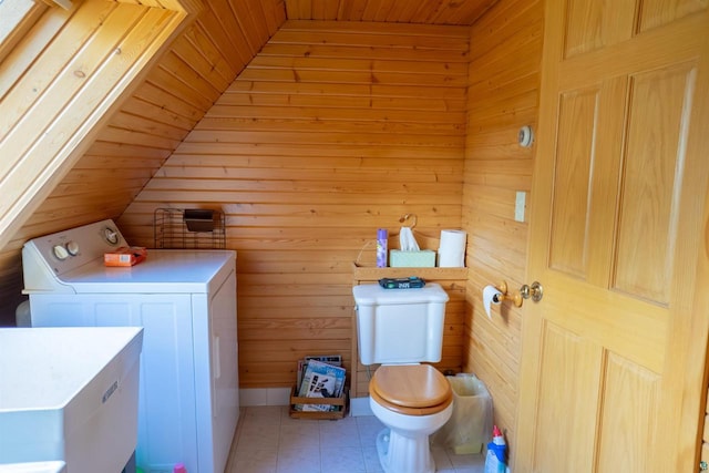 laundry area with wooden ceiling, washing machine and clothes dryer, light tile flooring, and wooden walls