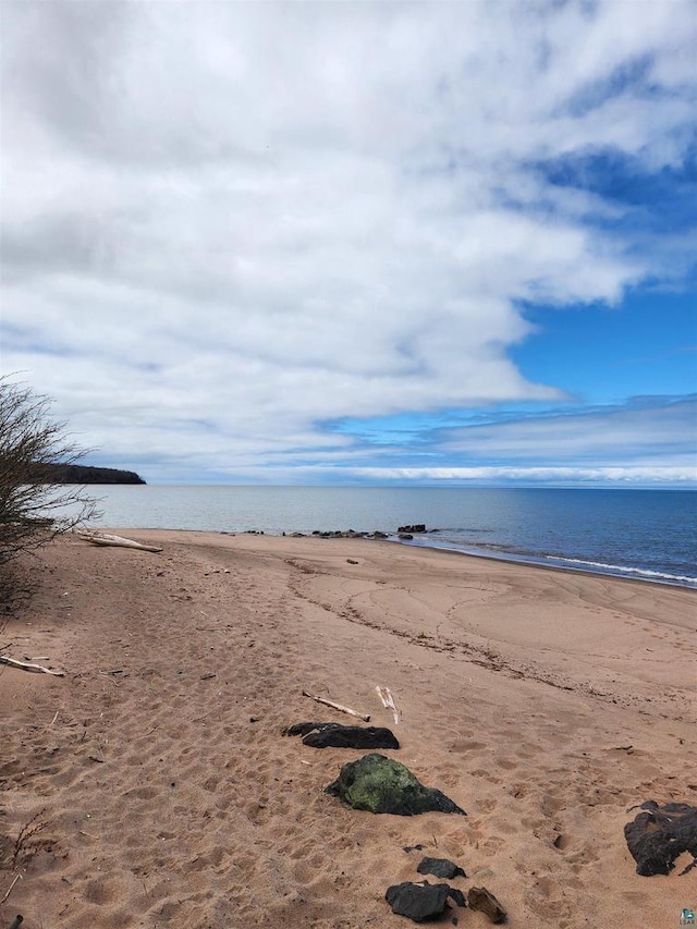 property view of water featuring a beach view