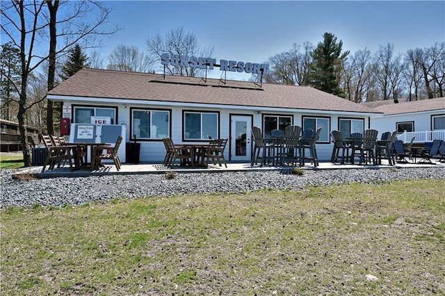 rear view of property featuring a lawn and a patio