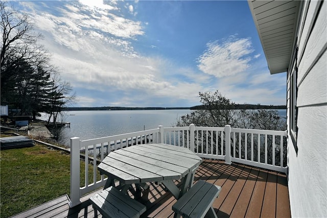 wooden terrace featuring a water view