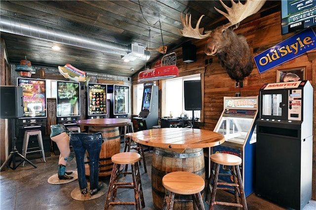 bar featuring vaulted ceiling and concrete flooring