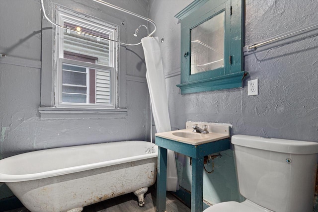 bathroom featuring a tub to relax in and toilet